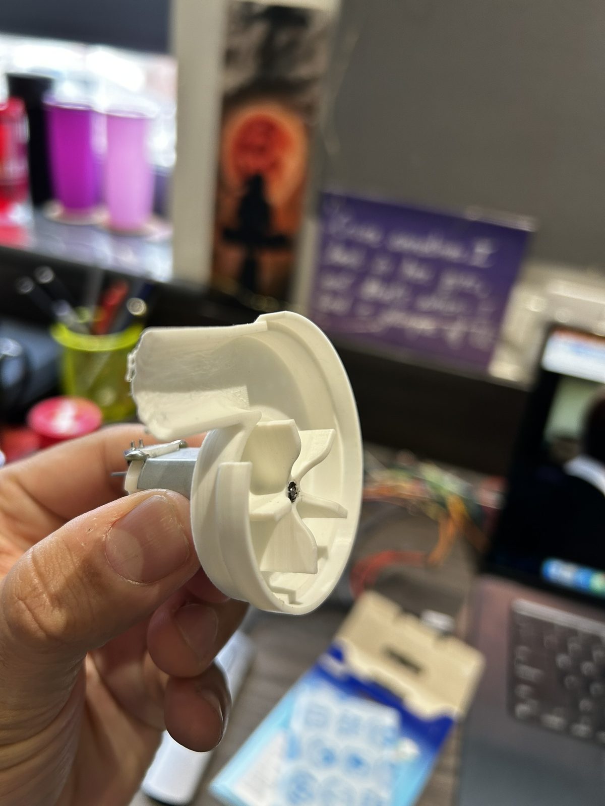 The 3D-printed turbine housing with its motor and fan blades fitted inside.