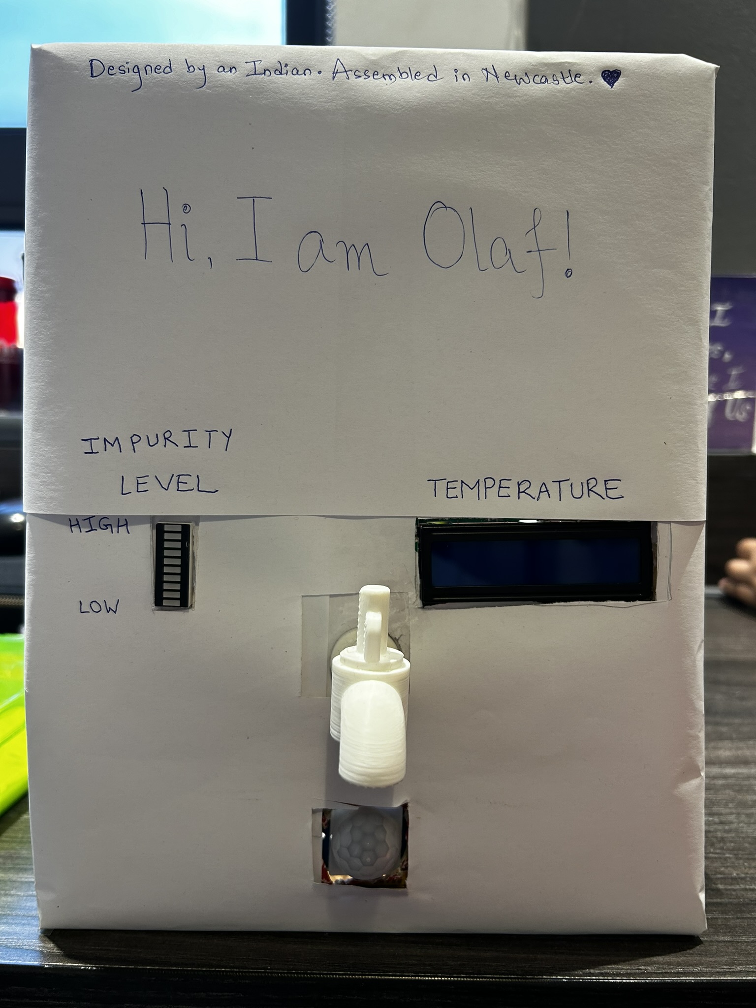 The finished smart tap prototype, showing impurity level and temperature readouts on its front panel.