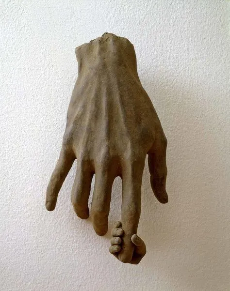 A sculpted clay hand, weathered and adult, cradling a small child's hand by its fingertips.